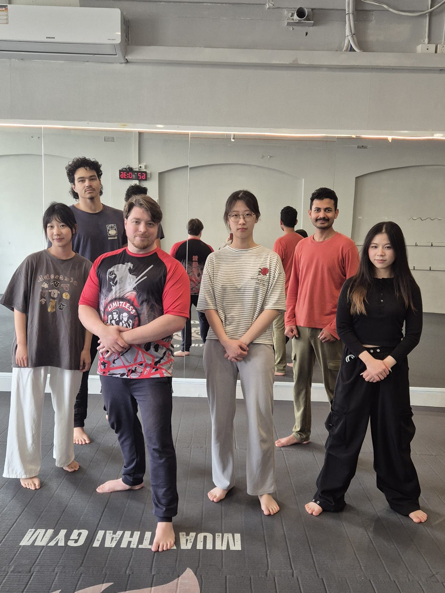 Class group photo on the mats at the Muay Thai gym